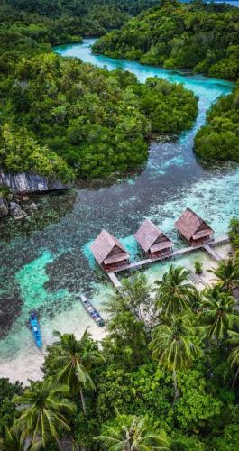 an aerial view of a resort on a tropical island at Beser Bay Homestay in Besir