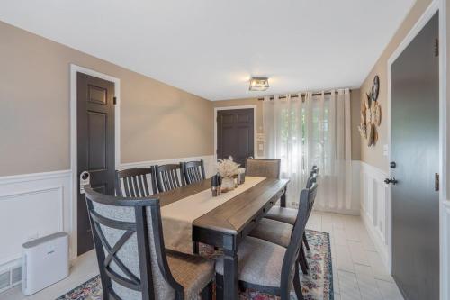a dining room with a wooden table and chairs at Comfy & cozy 4BR minutes to SU, Hospitals, & DT in Syracuse