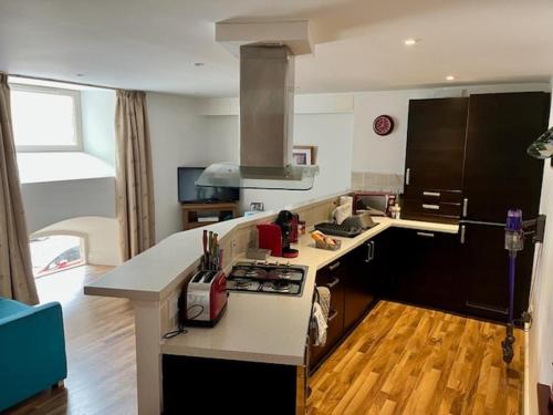 a kitchen with a stove and a counter top at Stunning spacious Apartment on River Ness in Inverness