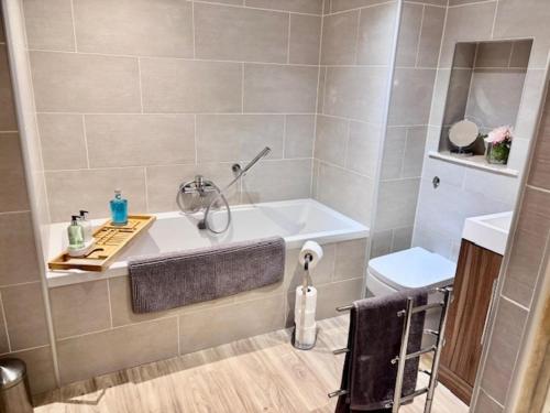 a bathroom with a bath tub and a sink at Stunning spacious Apartment on River Ness in Inverness