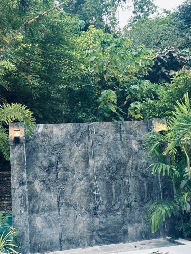 a concrete wall with a shower on top of it at Villa del Sol 1 Barkada Rooms in Guinauayan