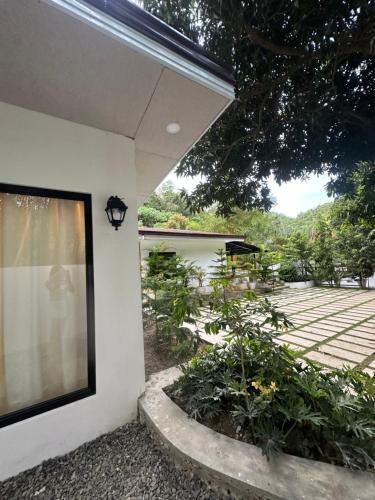 a window on the side of a house at Villa del Sol 1 Barkada Rooms in Guinauayan
