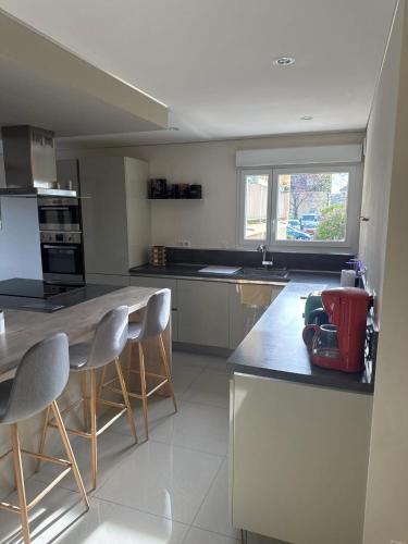 une cuisine avec un comptoir, des chaises et une table dans l'établissement Appartement moderne à Metz 76 m², climatisé, à Metz
