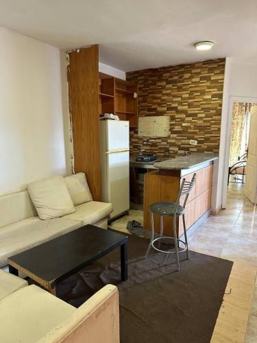 a living room with a couch and a kitchen at استوديو صويلح studio sweileh 2 in Amman