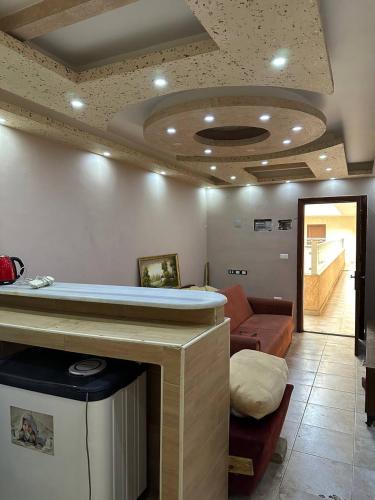 a living room with a bar and a couch at استوديو صويلح studio sweileh 2 in Amman