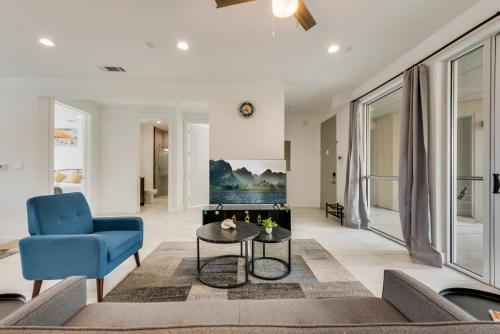a living room with a blue chair and a table at Metro View 2BR I Parking I King Bed I Workspace in Dallas