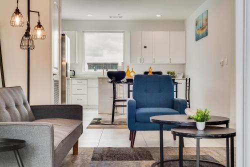 a living room with a blue chair and a table at Metro View 2BR I Parking I King Bed I Workspace in Dallas