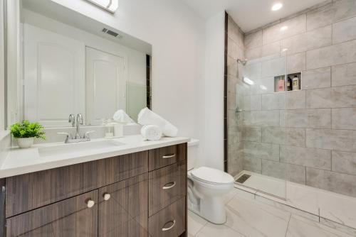 a bathroom with a sink and a toilet and a shower at Metro View 2BR I Parking I King Bed I Workspace in Dallas