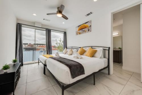 a bedroom with a bed and a large window at Metro View 2BR I Parking I King Bed I Workspace in Dallas