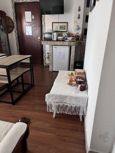 a living room with a table and a kitchen at Da Adriana Guesthouse in Santa Teresa Gallura