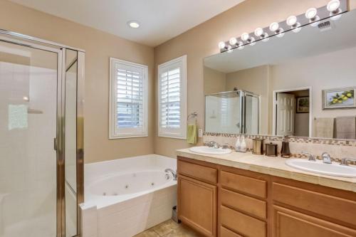 a bathroom with two sinks and a tub and a shower at Indian Palms Vacation Villa Permit# 50273 in Indio