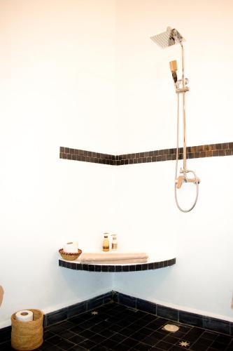 a bathroom with a shower and a sink at Riad Le Khan Mogador in Essaouira