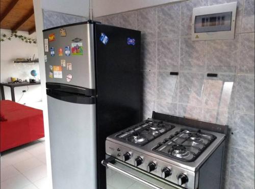 a kitchen with a stove and a refrigerator at Acogedora Habitación Privada - Belén Rosales Laureles in Medellín