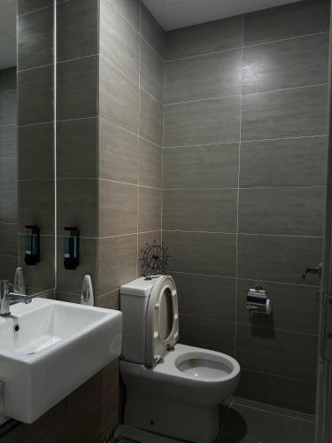 a bathroom with a toilet and a sink at 3volution Stays in Petaling Jaya