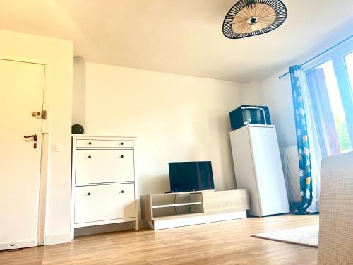 Cette chambre comprend une commode blanche et un réfrigérateur. dans l'établissement Cozy apartment between Paris & Disneyland, à Le Perreux-Sur-Marne