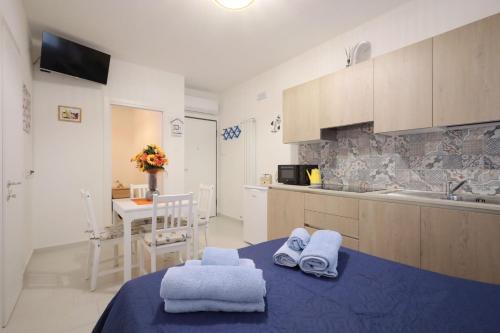 a kitchen with towels on a table and a sink at Residenza Ca' Magoga in Chioggia