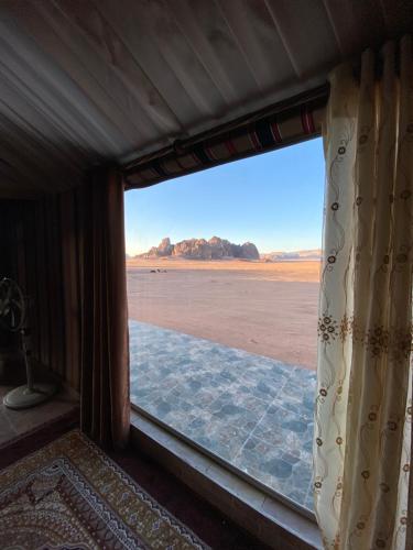 a window in a room with a view of the desert at Rum Aranda camp & Jeep Tour in Wadi Rum