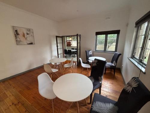 a room with a white table and chairs at 30 on 6th in Bellville