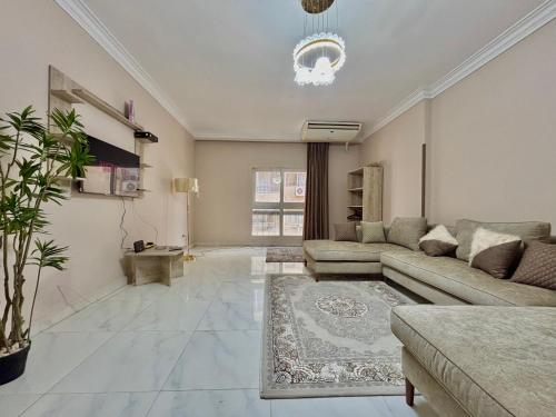 a living room with a couch and a rug at Elite Apartments in Mohandseen - Families only in Cairo