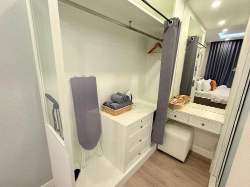 a bathroom with a vanity and a mirror and a sink at The Blu X Ocean view Family top floor in Ban Bang Saen (1)