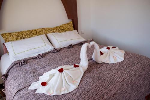 two swans dressed up on a bed at Riad Le Khan Mogador in Essaouira