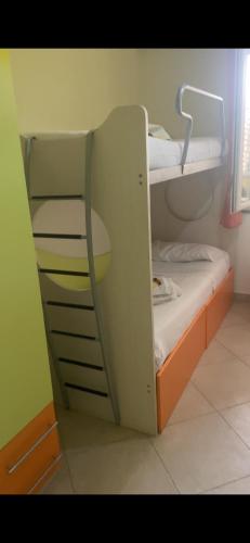 a bunk bed with an open door in a room at La Baia Di Ulisse in Venetico