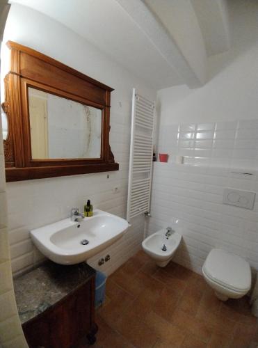 a white bathroom with a sink and a toilet at Agriturismo Casa Greppo in San Venanzo
