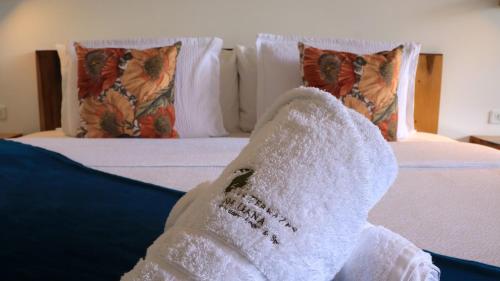 a white towel is sitting on a bed at Las Terrazas de Dana Boutique Lodge & Spa in Mindo