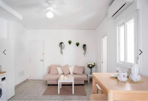 a white living room with a couch and a table at Casco histórico de Estepona in Estepona