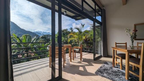 a dining room with a view of the mountains at Las Terrazas de Dana Boutique Lodge & Spa in Mindo