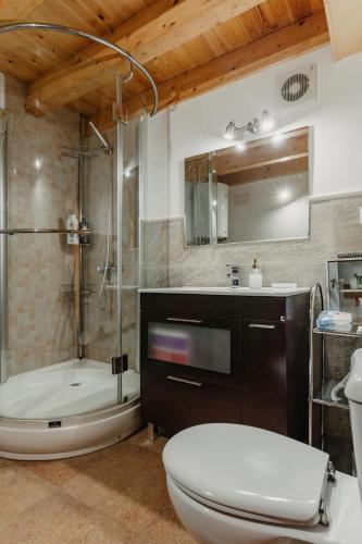 a bathroom with a tub and a toilet and a sink at La Casina de Maxa in Suares