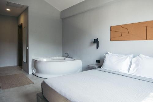 a bedroom with a bed and a bath tub at Primus Nefes Adult Only in Alacati