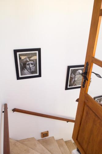 two framed pictures on a wall next to a stairway at Riad Le Khan Mogador in Essaouira