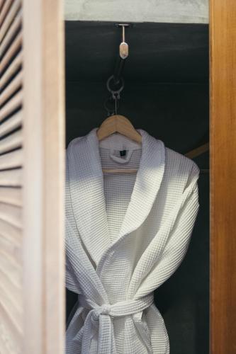 a white dress on a hanger in a window at Primus Nefes Adult Only in Alacati