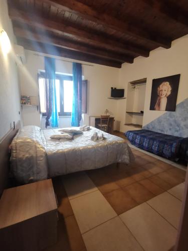a bedroom with two beds with blue drapes at La taverna del gufo bed & breakfast in Sarule