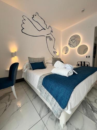 a bedroom with a bed with a drawing on the wall at Positano Art Hotel Pasitea in Positano