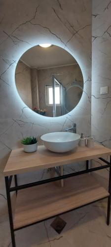 a bathroom with a sink and a mirror at Golden horizon Cavtat in Cavtat