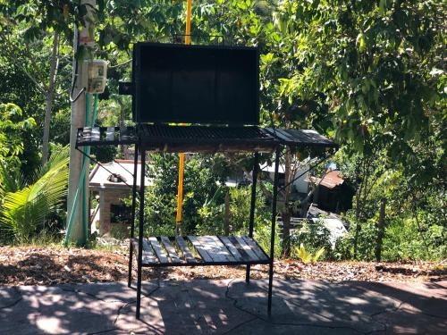 a stand with a tv on top of it at Finca las palmas in Puerto Triunfo