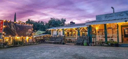 a group of buildings with tables and chairs at night at Genas's Sierra Inn & Restaurant in Dunlap