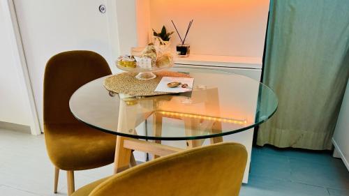 a dining room table with chairs and a glass table at The Dream in Massa Lubrense