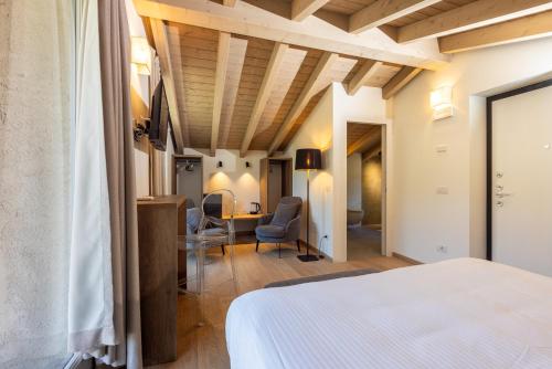 a bedroom with a bed and a desk and chairs at Residenza Sassella in Sondrio