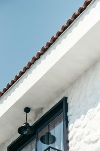 a window on the side of a white house at Primus Nefes Adult Only in Alacati