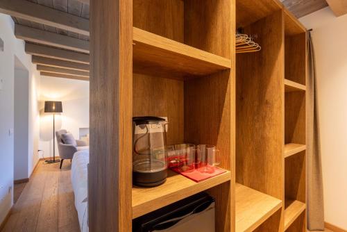 a wooden cabinet with a blender in a room at Residenza Sassella in Sondrio