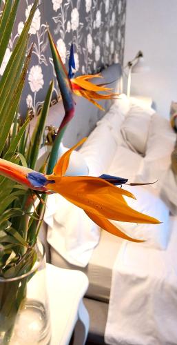 a flower in a vase on a bed at VILLA NABRISA MARBELLA, 5 BEDROOM, PRIVATE POOL, GARDEN, BBQ in Marbella