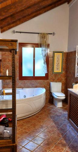 a large bathroom with a tub and a toilet at VILLA NABRISA MARBELLA, 5 BEDROOM, PRIVATE POOL, GARDEN, BBQ in Marbella