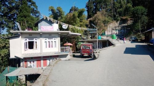 a red truck parked on the side of a road at Yellow Bamboo Homestay in Mangpu