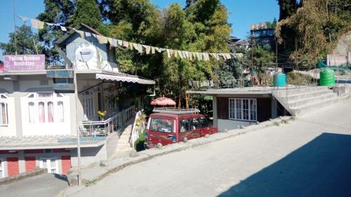 a red van parked in front of a building at Yellow Bamboo Homestay in Mangpu