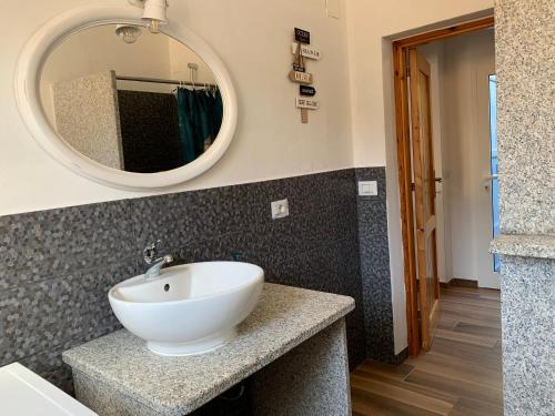 a bathroom with a white sink and a mirror at Terra in Valledoria