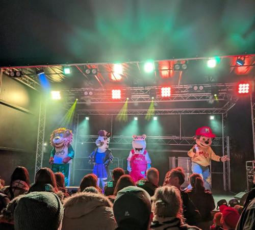 a crowd of people watching three cartoons on a stage at The Palm in Rhyl