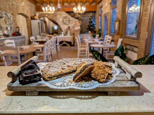 a piece of cake on a cutting board on a table at Agriturismo le Fontanelle da Valente in Montichiari